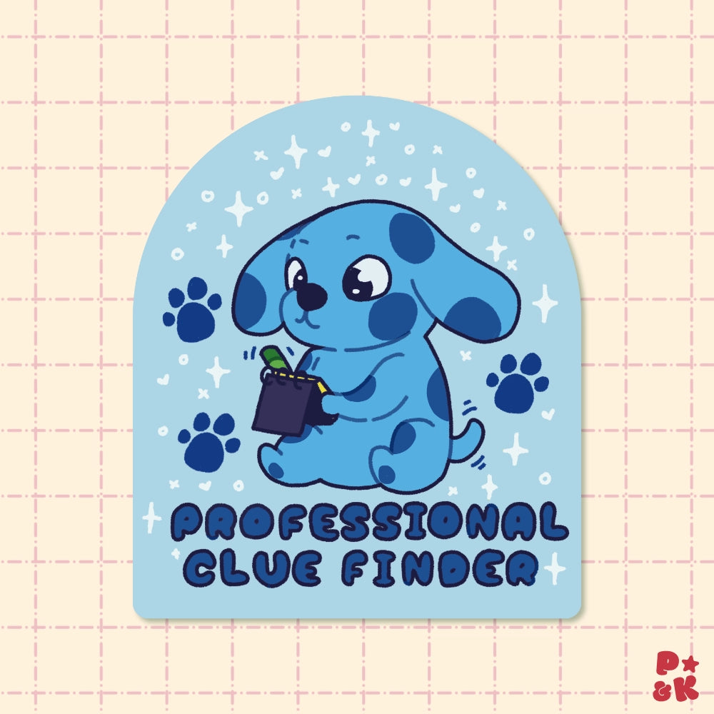 A die-cut sticker featuring a cute blue cartoon puppy holding a magnifying glass, surrounded by paw prints and stars on a light blue arched background. The text 'PROFESSIONAL CLUE FINDER' is printed at the bottom.
